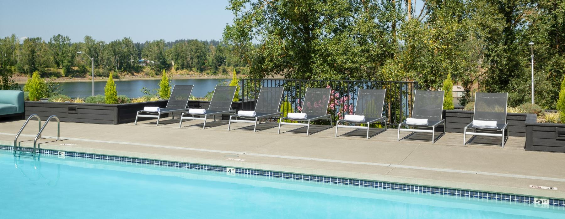 a pool with chairs around it