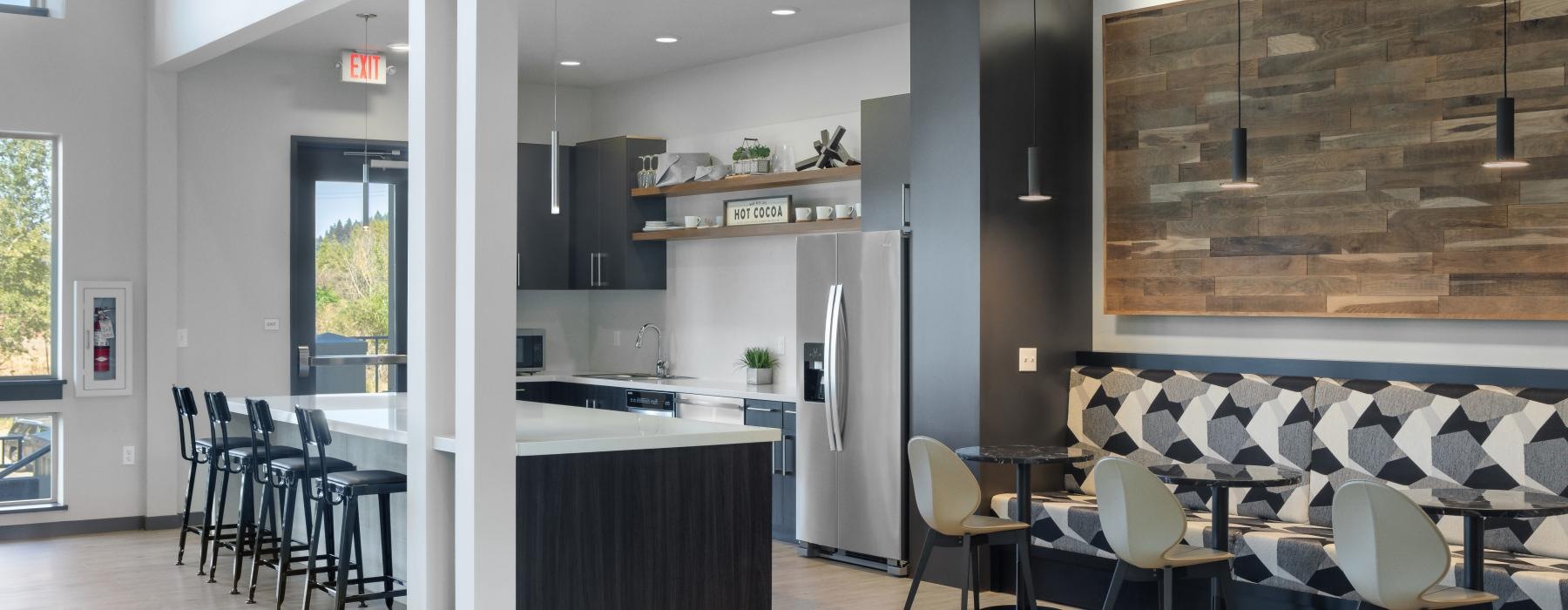 a kitchen with a bar and chairs